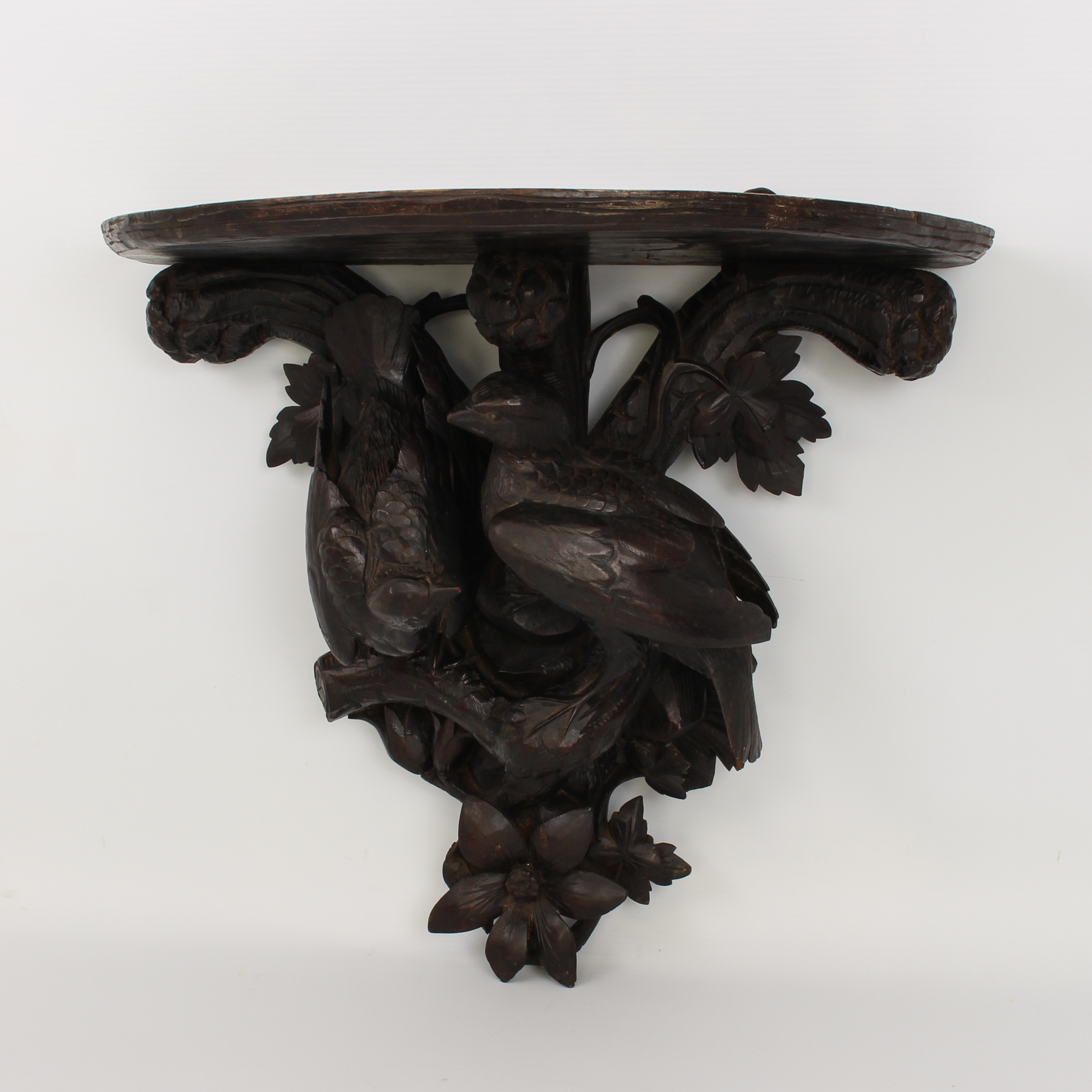 A late 19th century French carved and ebonised wooden clock bracket - probably lime wood, the demi- - Image 2 of 4