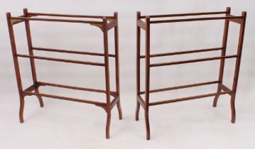 A pair of Edwardian mahogany double towel rails - with three rails to each side, on swept