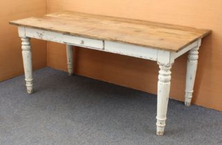 An oak farmhouse kitchen dining table in 19th century style - the rustic, planked top raised on an