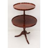 A reproduction Georgian-style mahogany two-tier dumb waiter - the two graduated circular tiers