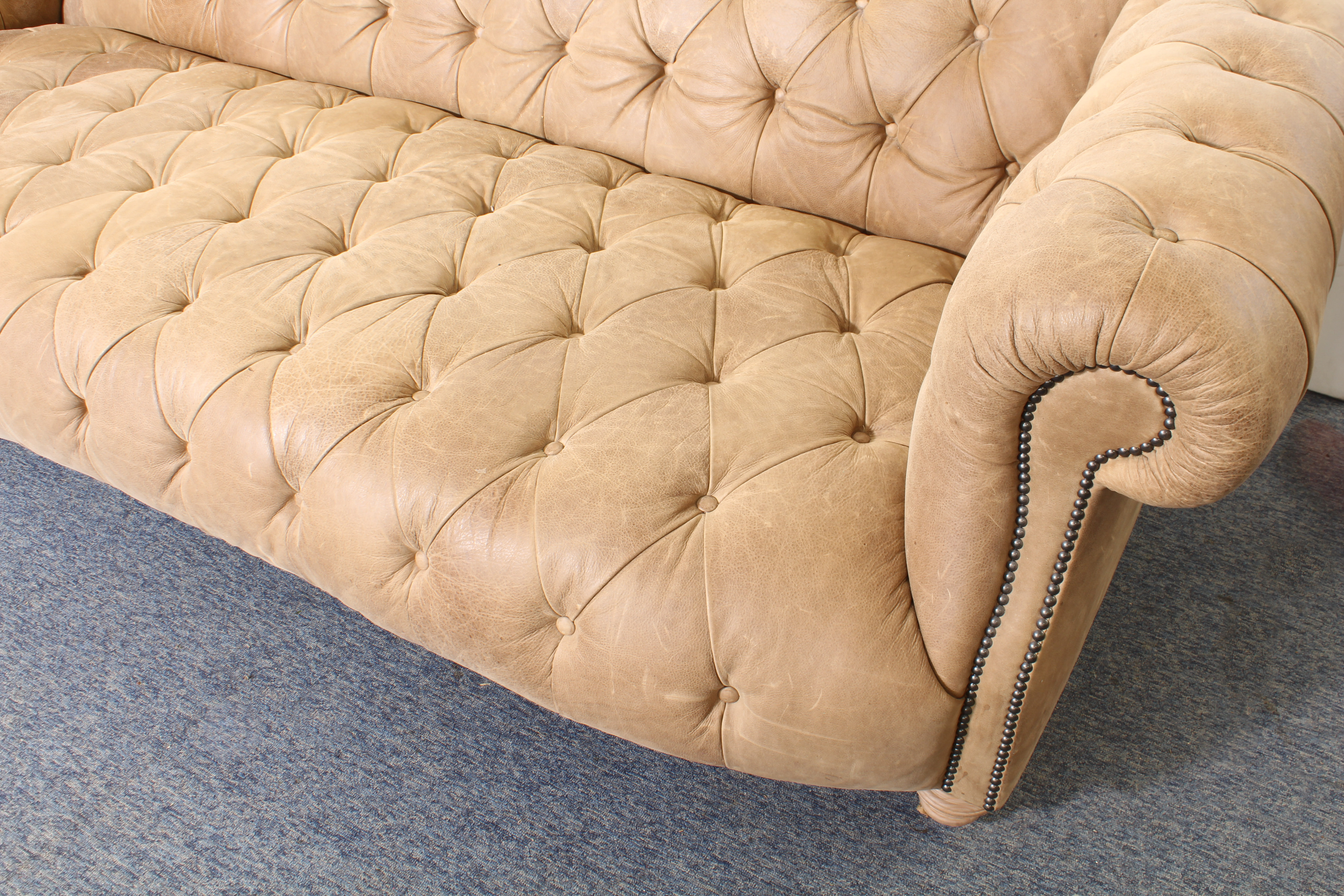 A leather Chesterfield three-seater sofa - modern, in soft pale-brown grained leather, raised on - Image 3 of 4