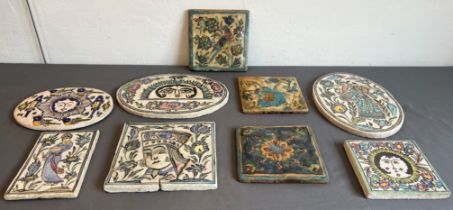 A collection of nine Persian glazed tiles - some antique, including three oval tiles, one 30 cm tile
