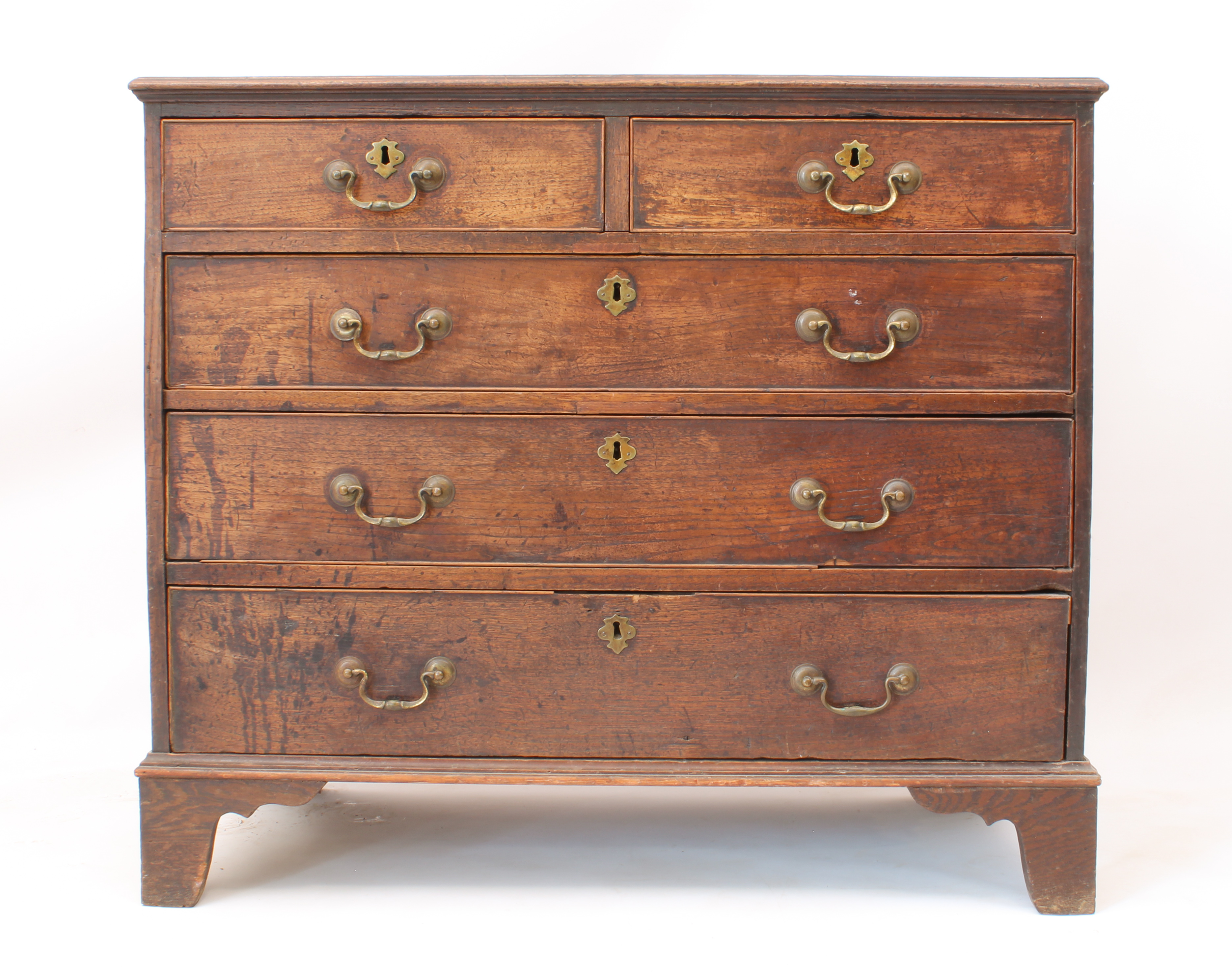 A George III oak and mahogany crossbanded straight-front chest of drawers - the moulded top over two