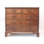 A George III oak and mahogany crossbanded straight-front chest of drawers - the moulded top over two