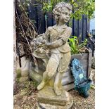 A composite stone garden statue of a boy holding a fruit basket - on a square base, 75cm high (crack