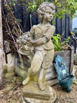 A composite stone garden statue of a boy holding a fruit basket - on a square base, 75cm high (crack