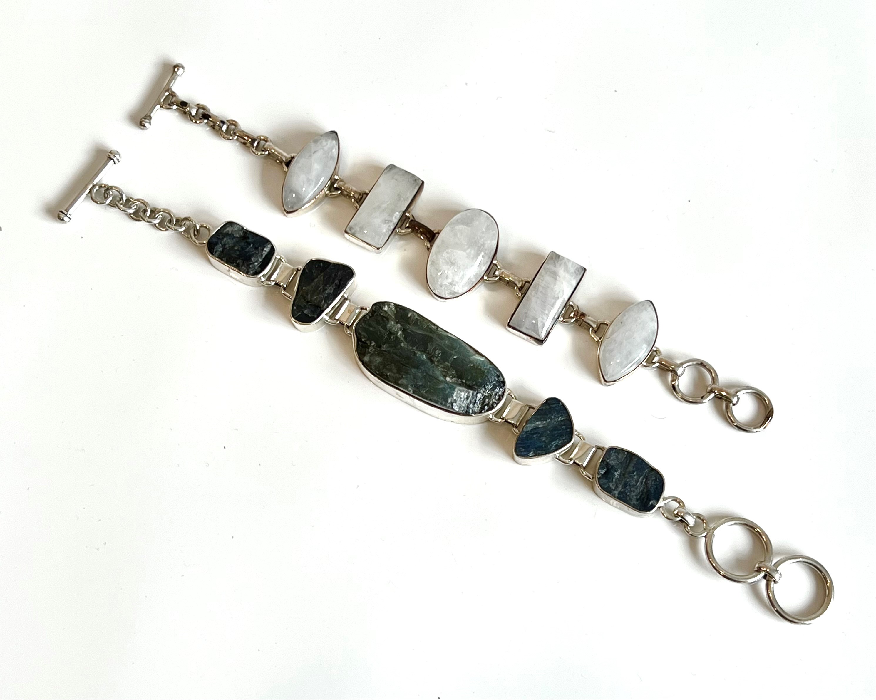 Two sterling silver and gemstone bracelets: 1. five polished cabochon moonstones in alternate