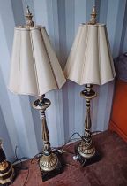 PAIR OF BLACK & GILT TABLE LAMPS WITH REEDED COLUMNS ON SQUARE BASES.