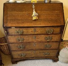 19TH CENTURY OAK BUREAU WITH FALL FRONT OVER 4 DRAWERS ON BRACKET SUPPORTS.