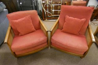 PAIR OF ERCOL OAK FRAMED ARMCHAIRS WITH BERGERE PANEL BACKS & SIDE