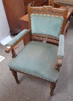 LATE 19TH CENTURY OAK OPEN ARMCHAIR WITH DECORATIVE CARVING ON TURNED SUPPORTS