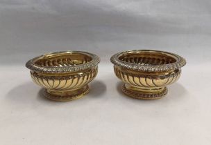 PAIR OF GEORGIAN SILVER GILT CIRCULAR PEDESTAL SALTS BY EMES & BARNARD,