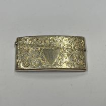 SILVER CURVED CARD CASE WITH FOLIATE SCROLL DECORATION BIRMINGHAM 1906 - 8CM LONG,