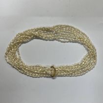 MULTI-STRAND PEARL NECKLACE WITH A 14K GOLD CLASP IN A PETER CHOI HONG KONG CASE