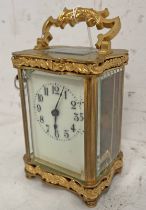 BRASS CARRIAGE CLOCK WITH WHITE DIAL, GLASS PANELS, EMBOSSED DECORATION TO TOP AND BOTTOM,