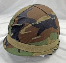 AMERICAN STEEL COMBAT HELMET WITH CAMO COVER & LINER WITH LABEL THAT READS 'LINER,