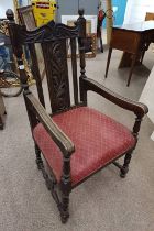 19TH CENTURY OAK OPEN ARMCHAIR WITH DECORATIVE CARVED BACK ON TURNED SUPPORTS