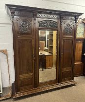 19TH CENTURY MAHOGANY TRIPLE DOOR WARDROBE WITH CENTRALLY SET MIRROR FLANKED BY 2 CARVED PANEL