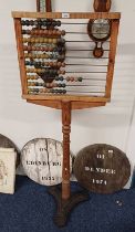 19TH CENTURY PINE ABACUS ON TURNED COLUMN WITH CAST IRON BASE.