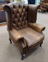 BROWN LEATHER BUTTONED WINGBACK ARMCHAIR ON SHORT QUEEN ANNE SUPPORTS LABELLED 'WINCHESTER