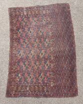 RED GROUND MIDDLE EASTERN SADDLE BACK RUG WITH GEOMETRIC DESIGN AND SQUARE PANELS TO CENTRE,