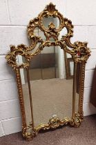 GILT WALL MIRROR WITH FLORAL & REGAL DESIGN TO FRAME,