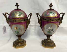PAIR OF PORCELAIN AND GILT DOUBLE HANDLED LIDDED URNS WITH FLORAL DECORATION,