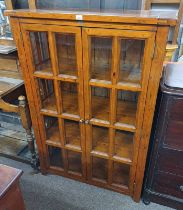 OAK DISPLAY CABINET WITH 2 GLAZED PANEL DOORS OPENING TO SHELVED INTERIOR LABELLED 'THE IRISH COAST