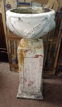 PAINTED RECONSTITUTED STONE GARDEN URN ON TALL PLINTH,