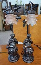 PAIR OF DECORATIVE METAL TABLE LAMPS MODELLED AFTER LADY WITH PINK GLASS SHADES