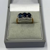 9CT GOLD SAPPHIRE & DIAMOND CLUSTER RING WITH 3 OVAL SAPPHIRES IN A SURROUND OF DIAMONDS