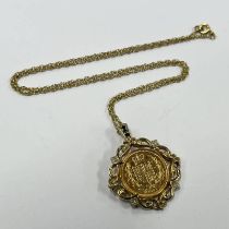 2002 SHIELD BACK HALF SOVEREIGN IN A 9CT GOLD SAPPHIRE & DIAMOND MOUNT ON A FINE CHAIN - 9.