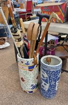 2 PORCELAIN STICK STANDS WITH VARIOUS STICKS, UMBRELLAS,