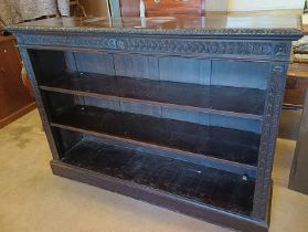 19TH CENTURY CARVED OAK OPEN BOOKCASE WITH ADJUSTABLE SHELVES ON PLINTH BASE.