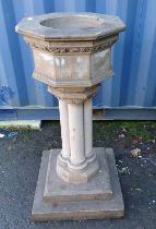 RECONSTITUTED STONE FONT ON QUAD-PEDESTAL WITH SQUARE PLINTH BASE.