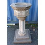 RECONSTITUTED STONE FONT ON QUAD-PEDESTAL WITH SQUARE PLINTH BASE.