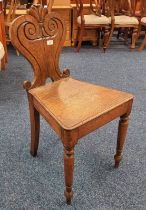 19TH CENTURY OAK HALL CHAIR WITH DECORATIVE CARVED BACK ON TURNED SUPPORTS