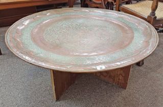 LARGE COPPER MIDDLE EASTERN STYLE CIRCULAR TRAY WITH ETCHED DECORATION ON STAND.