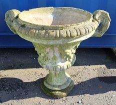 RECONSTITUTED STONE GARDEN URN ON CIRCULAR PLINTH BASE.