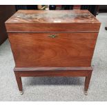 LATE 19TH CENTURY INLAID MAHOGANY CELLARETTE ON REEDED SQUARE TAPERED SUPPORTS.