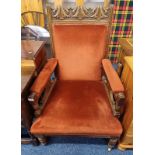 OAK FRAMED GENTLEMEN'S ARMCHAIR WITH CARVED DECORATION ON TURNED SUPPORTS.