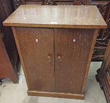 20TH CENTURY OAK CABINET WITH 2 PANEL DOORS OPENING TO SHELVED INTERIOR ON PLINTH BASE.