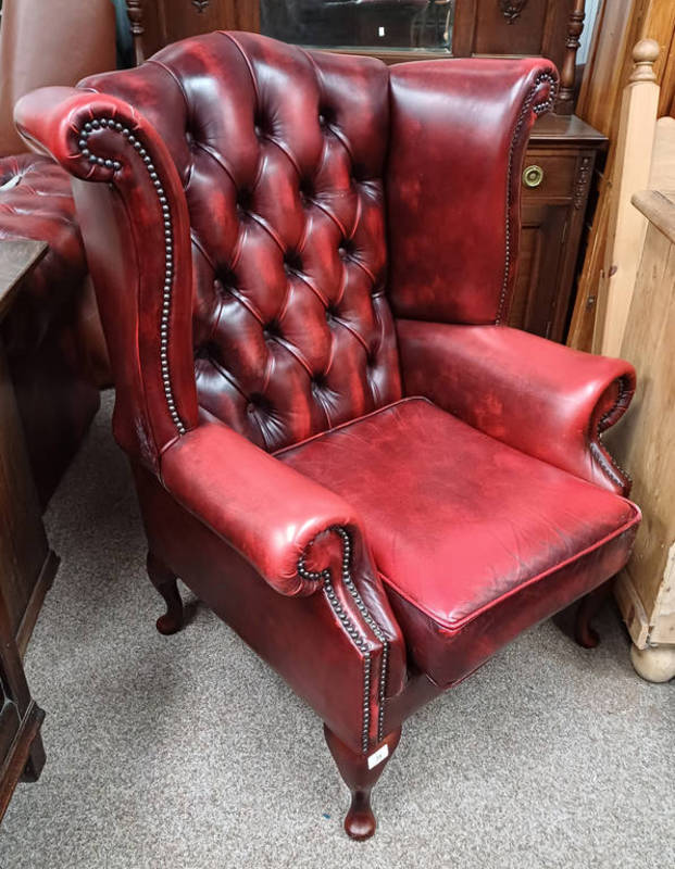OX-BLOOD RED LEATHER BUTTONED WINGBACK ARMCHAIR ON SHORT- QUEEN ANNE SUPPORTS.