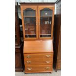 BUREAU BOOKCASE WITH 2 GLAZED PANEL DOORS OPENING TO SHELVED INTERIOR OVER BASE WITH FALL FRONT