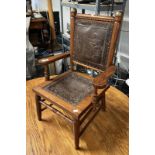 OAK FRAMED CHILD'S ARMCHAIR WITH EMBOSSED LEATHER PANEL BACK & SEAT WITH CLASSICAL SCENE DECORATION