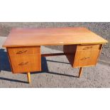 TEAK KNEE-HOLE DESK WITH 4 DRAWERS ON TAPERED SUPPORTS. SIGNED MORRIS OF GLASGOW TO DRAWER.