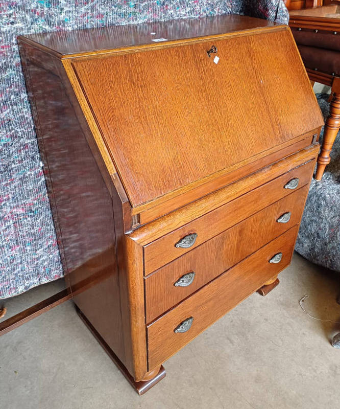 20TH CENTURY OAK BUREAU WITH FALL FRONT OVER 3 GRADUATED DRAWERS LABELLED LEBUS TO INTERIOR.