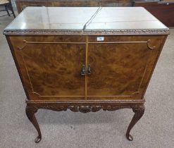 20TH CENTURY BURR WALNUT COCKTAIL CABINET WITH FITTED INTERIOR BEHIND 2 PANEL DOORS ON SHAPED