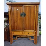 ORIENTAL CABINET WITH 2 PANEL DOORS OPENING TO SHELVED INTERIOR.