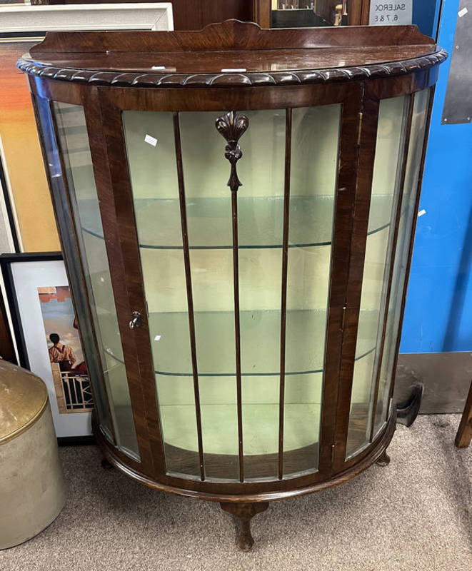 WALNUT DISPLAY CABINET WITH SINGLE GLAZED PANEL DOOR OPENING TO GLASS SHELVED INTERIOR ON SHAPED